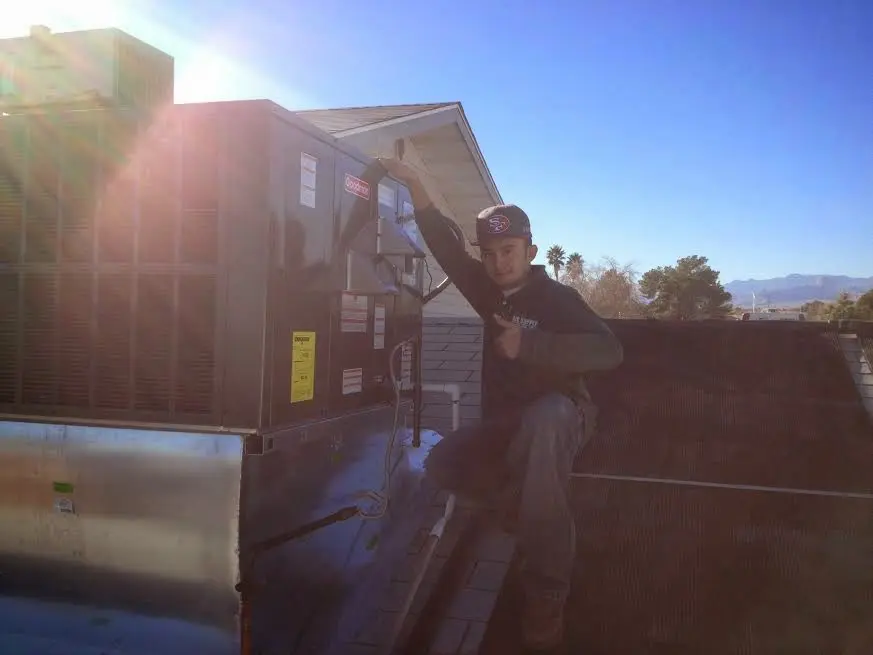 HVAC technician performing HVAC Inspection on a rooftop unit in Virginia Beach